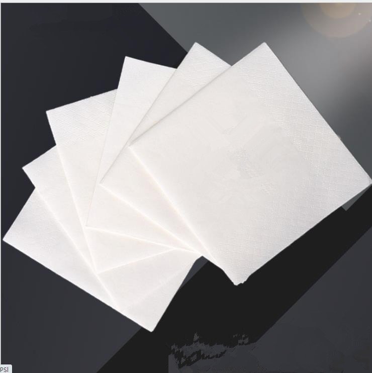 Quarter-folded embossed paper napkins fanned to show fold and surface