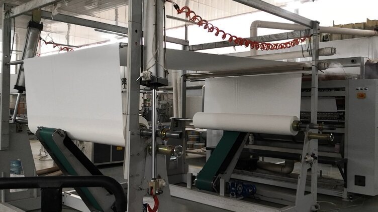 Tissue packaging line applying branded inner film and cartoning at Top Source Paper factory