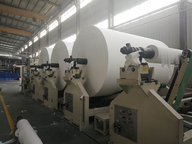 Virgin wood pulp parent reels mounted on the converting line