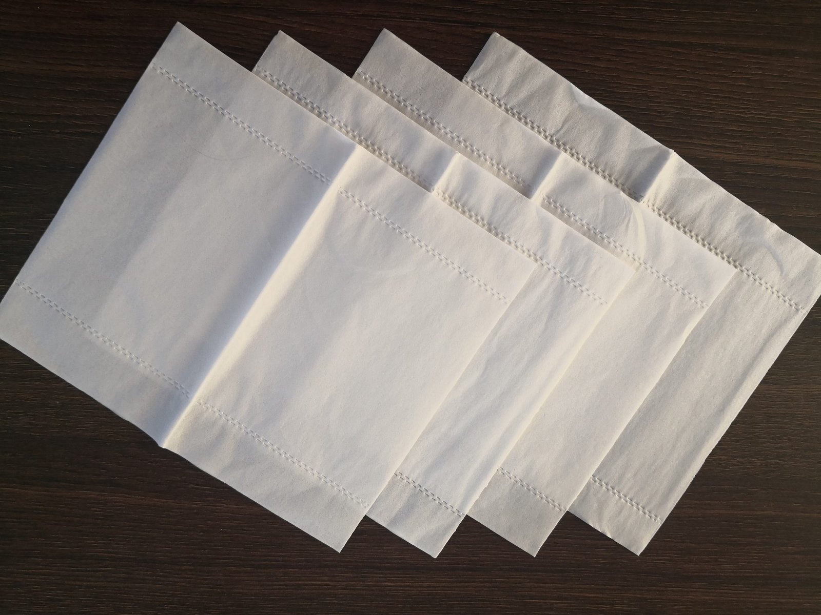 Unfolded facial tissue sheet showing full size and even embossing